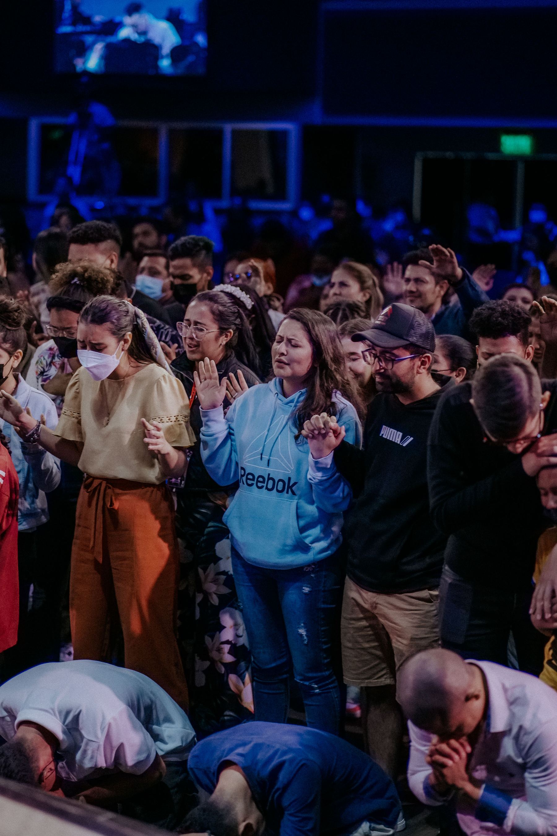 The Grace Fellowship congregation gathered together, hands raised in worship