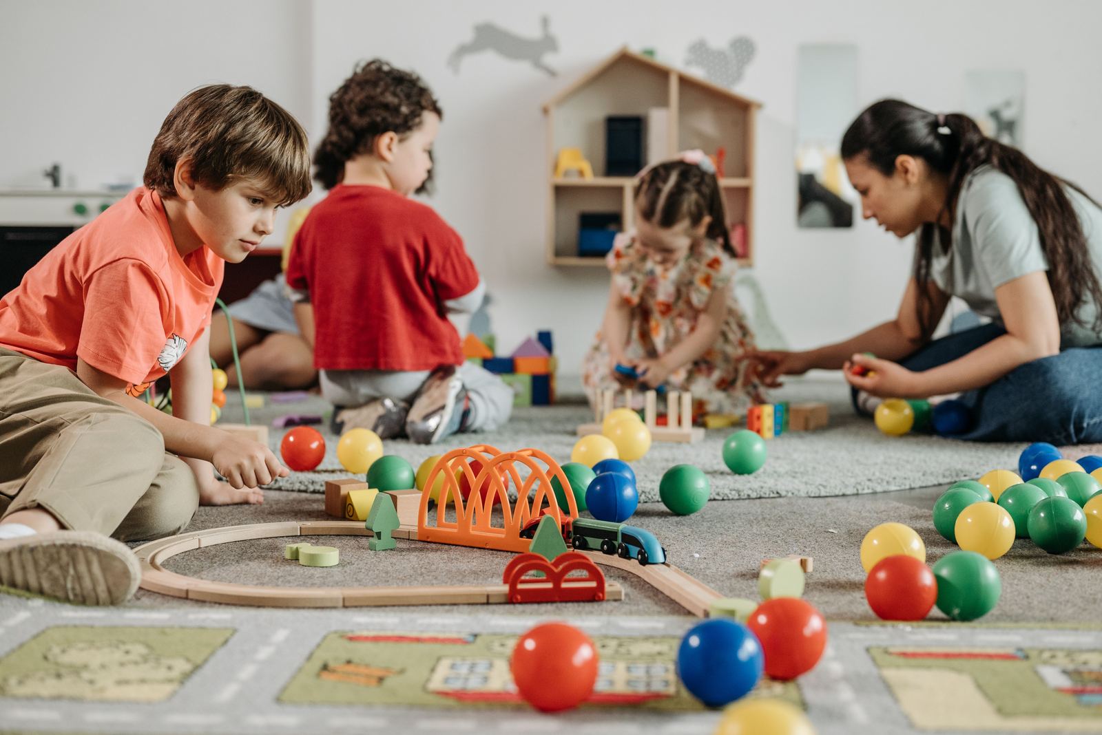A caregiver playing with toddlers in the church nursery