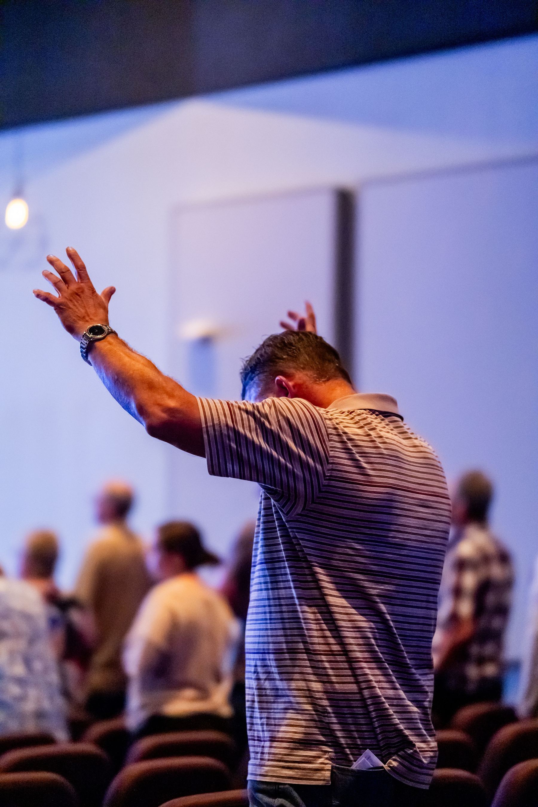 A volunteer reaching out in worship, ready to serve