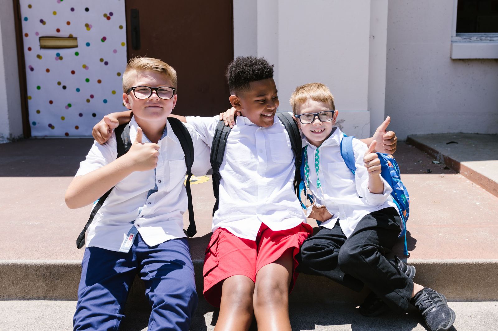 Students smiling together outside before a student ministry gathering